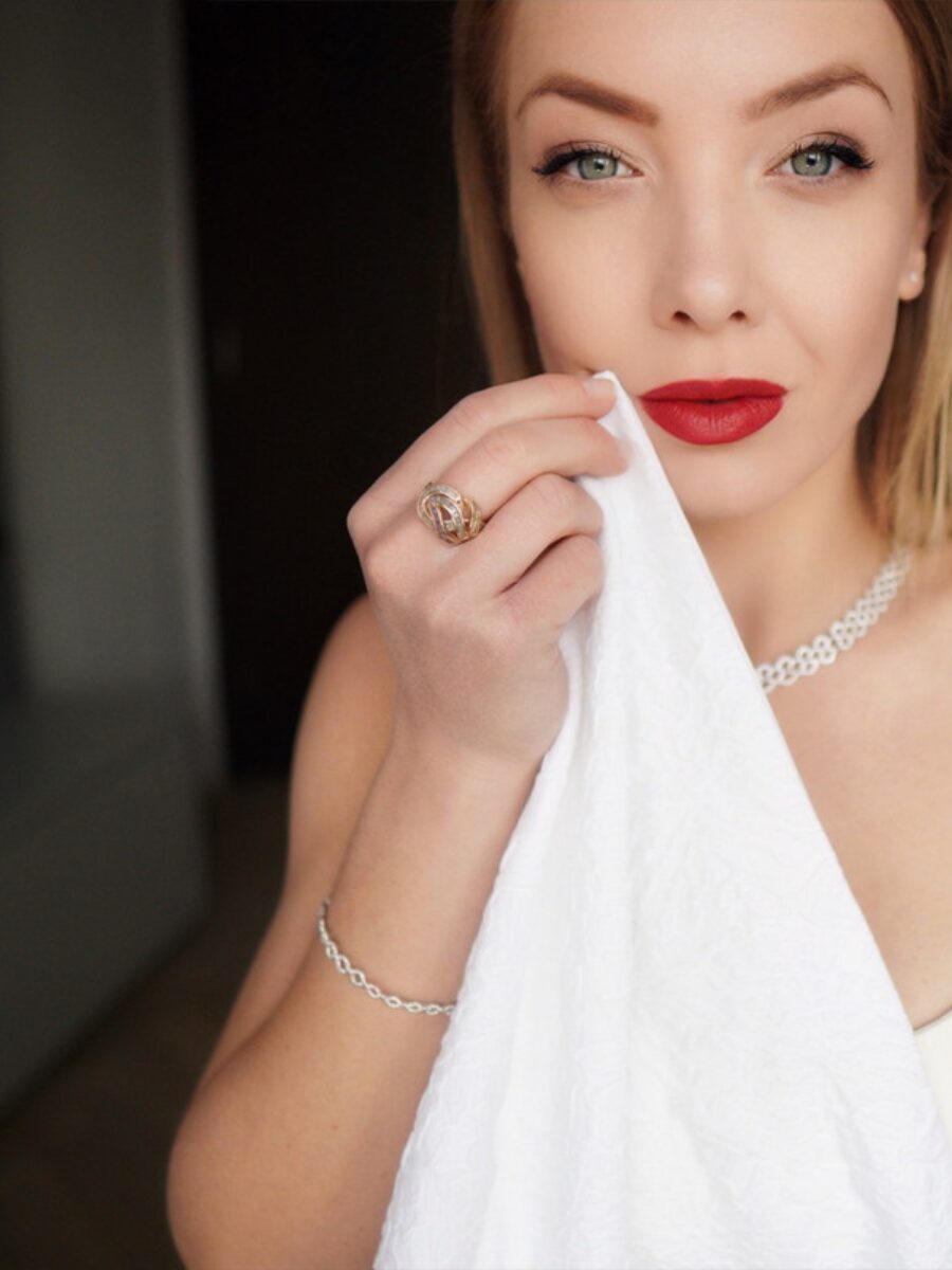 Elegant lady using a napkin at the table dining etiquette restaurant red lips silver jewellry