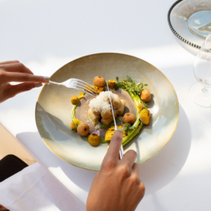 Fine dining in a restaurant holding a fork and knife