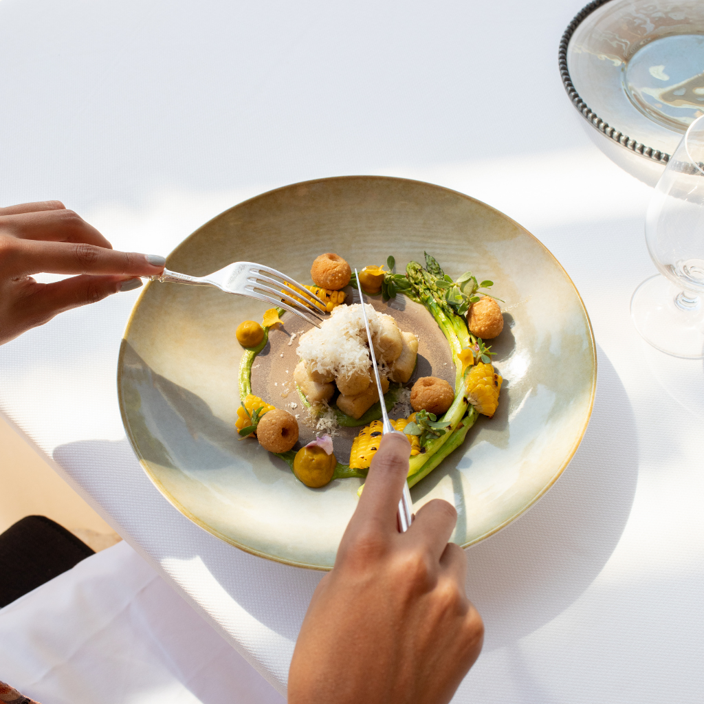 Fine dining in a restaurant holding a fork and knife